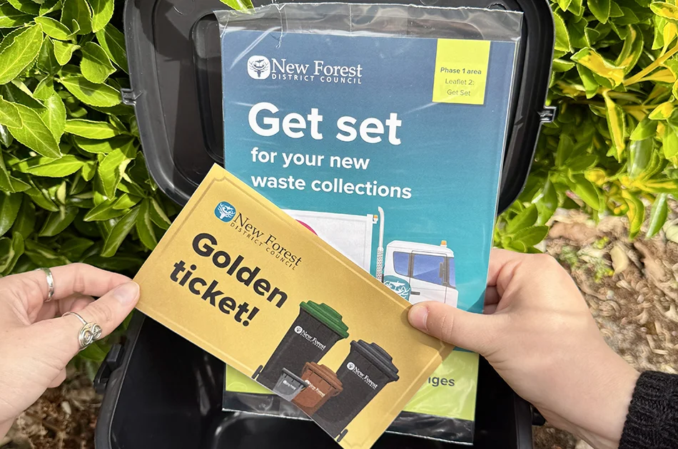 Golden ticket and 'Get Set' leaflet inside grey indoor food waste caddy